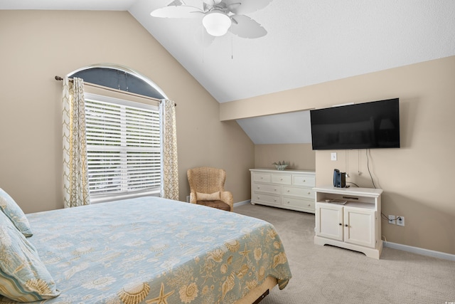 bedroom featuring lofted ceiling, light colored carpet, baseboards, and ceiling fan