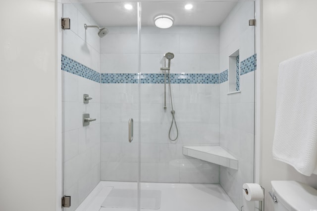 full bath with toilet, a shower stall, and recessed lighting
