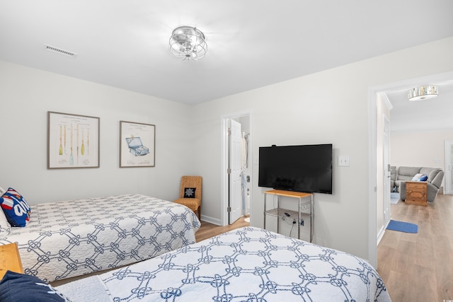 bedroom with light wood-style floors and baseboards