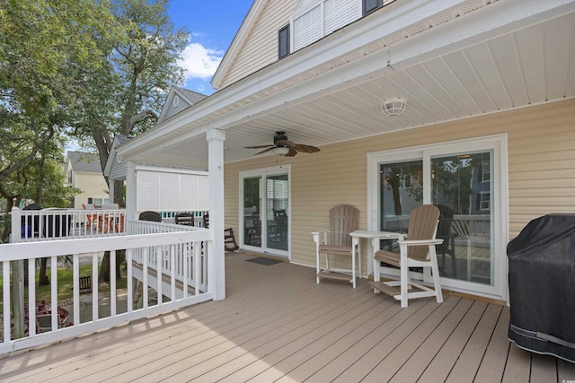 deck featuring a ceiling fan and a grill