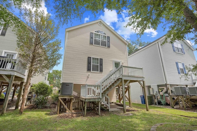 back of property featuring stairs, a yard, a wooden deck, and central AC unit