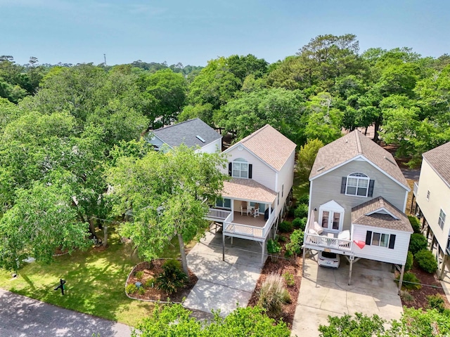 aerial view of property and surrounding area with a forest