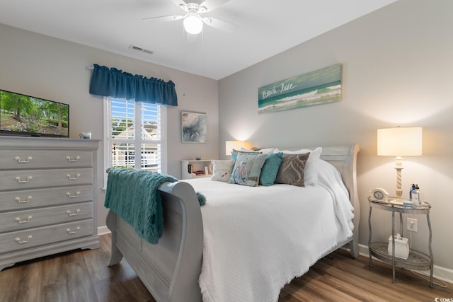 bedroom featuring wood finished floors, a ceiling fan, and baseboards