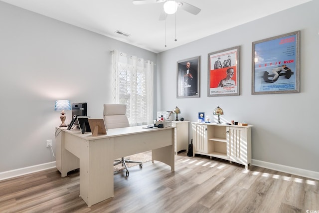 office space featuring light wood-style flooring, baseboards, and a ceiling fan