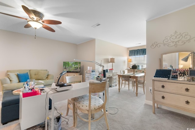 living area with ceiling fan and light carpet