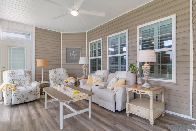 sunroom with a ceiling fan and an outdoor hangout area