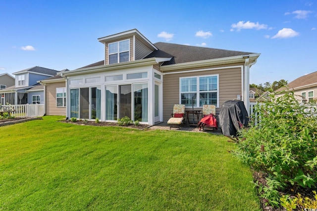 rear view of property featuring a sunroom