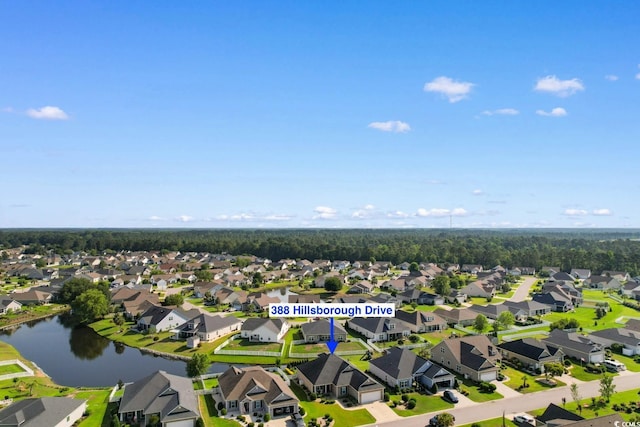 aerial view of residential area featuring a large body of water