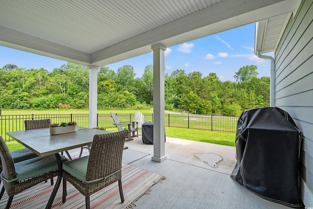 view of patio with outdoor dining area and a grill