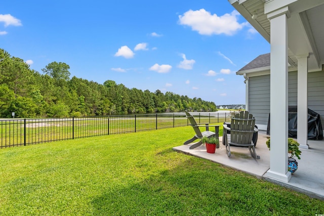 view of yard featuring a patio and a view of trees