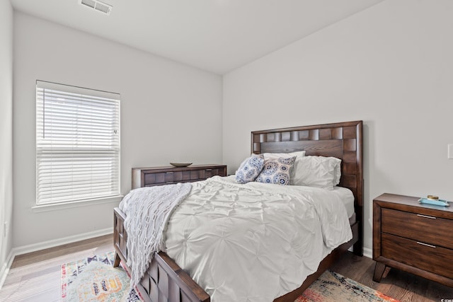 bedroom with wood finished floors and baseboards