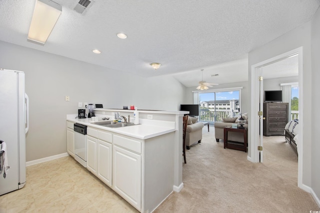 4506 W Harbor Ct Unit U-15, Little River, SC 29566 - kitchen with white appliances, a peninsula, a ceiling fan, a textured ceiling, and light countertops