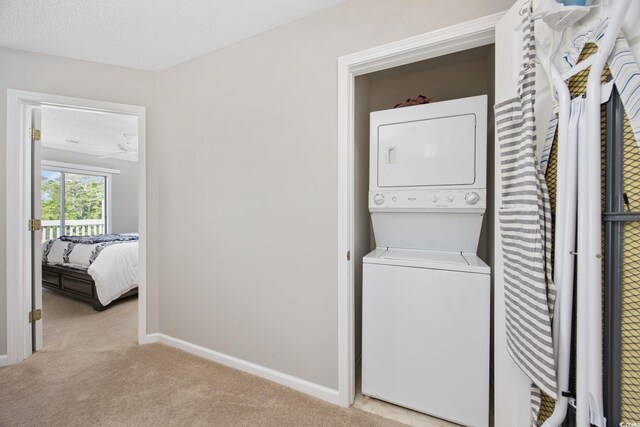 4506 W Harbor Ct Unit U-15, Little River, SC 29566 - laundry area with stacked washing machine and dryer, light carpet, and ceiling fan