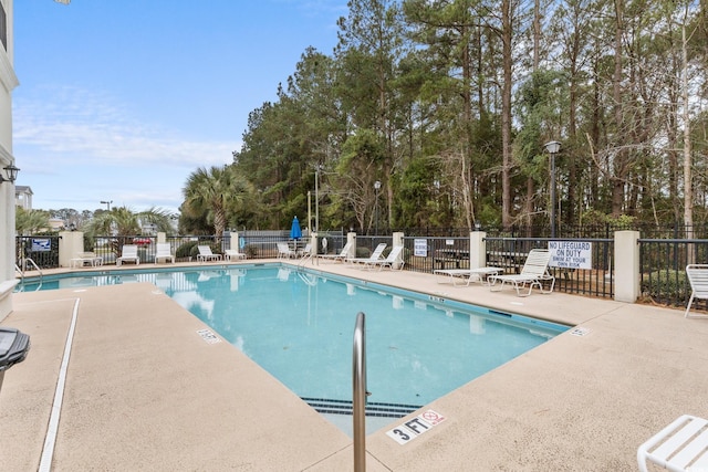 4506 W Harbor Ct Unit U-15, Little River, SC 29566 - community pool featuring a patio area and view of scattered trees