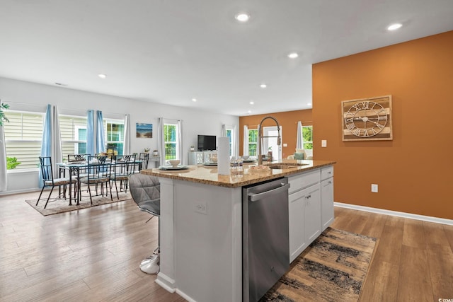 3021 Sistine St, Myrtle Beach, SC 29579 - kitchen featuring stainless steel dishwasher, a sink, white cabinetry, light stone countertops, and a kitchen island with sink