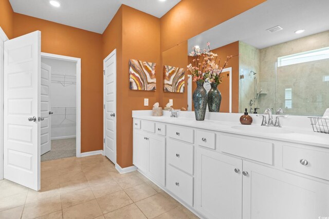 3021 Sistine St, Myrtle Beach, SC 29579 - bathroom featuring tiled shower, double vanity, baseboards, a spacious closet, and tile patterned floors