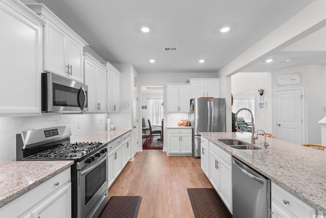 818 Mourning Dove Dr, Myrtle Beach, SC 29577 - kitchen with appliances with stainless steel finishes, a sink, white cabinets, recessed lighting, and decorative backsplash