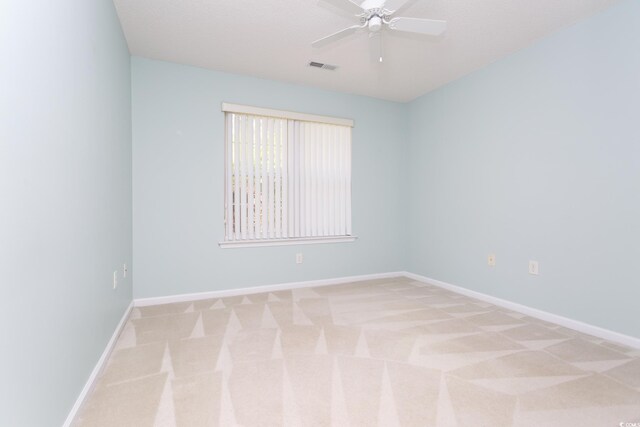 1044 Vestry Dr, Murrells Inlet, SC 29576 - spare room featuring light carpet, a ceiling fan, and baseboards