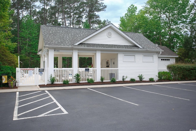 1044 Vestry Dr, Murrells Inlet, SC 29576 - view of front of house featuring a shingled roof, uncovered parking, and covered porch