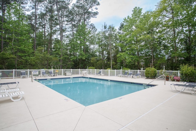 1044 Vestry Dr, Murrells Inlet, SC 29576 - community pool featuring a patio area and view of scattered trees