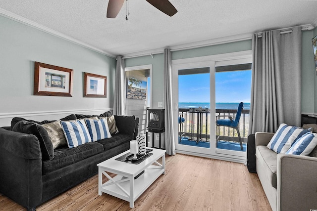 6000 N Ocean Blvd Unit 119, North Myrtle Beach, SC 29582 - living room with a water view, ceiling fan, a textured ceiling, ornamental molding, and light wood-style floors
