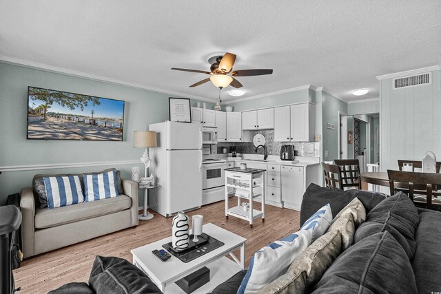 6000 N Ocean Blvd Unit 119, North Myrtle Beach, SC 29582 - living room featuring ornamental molding, a ceiling fan, light wood finished floors, and a textured ceiling