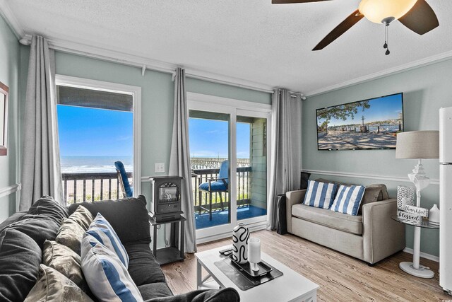 6000 N Ocean Blvd Unit 119, North Myrtle Beach, SC 29582 - living area with a textured ceiling, healthy amount of natural light, ceiling fan, light wood-type flooring, and ornamental molding