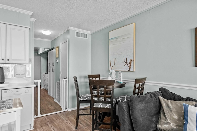 6000 N Ocean Blvd Unit 119, North Myrtle Beach, SC 29582 - dining space with ornamental molding, wood finished floors, and a textured ceiling