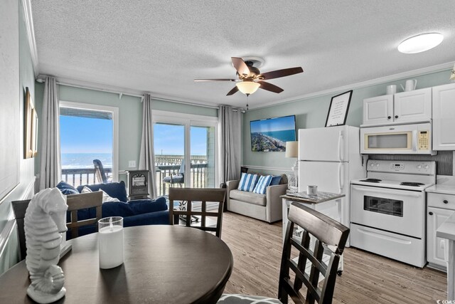 6000 N Ocean Blvd Unit 119, North Myrtle Beach, SC 29582 - dining space featuring ceiling fan, a textured ceiling, a water view, light wood-style floors, and crown molding