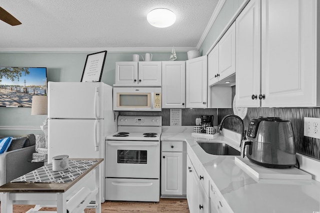 6000 N Ocean Blvd Unit 119, North Myrtle Beach, SC 29582 - kitchen with white appliances, a sink, ornamental molding, a textured ceiling, and white cabinets