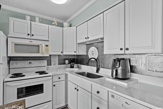 6000 N Ocean Blvd Unit 119, North Myrtle Beach, SC 29582 - kitchen featuring white appliances, a sink, white cabinetry, a textured ceiling, and crown molding