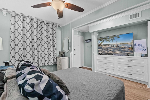 6000 N Ocean Blvd Unit 119, North Myrtle Beach, SC 29582 - bedroom with light wood-type flooring, crown molding, and a ceiling fan