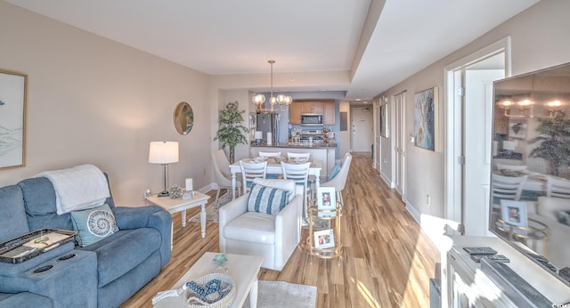 2100 Sea Mountain Hwy Unit 202, North Myrtle Beach, SC 29582 - living room with a chandelier, light wood finished floors, and baseboards