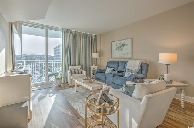 2100 Sea Mountain Hwy Unit 202, North Myrtle Beach, SC 29582 - living area with a wall of windows, wood finished floors, and baseboards