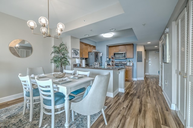 2100 Sea Mountain Hwy Unit 202, North Myrtle Beach, SC 29582 - dining area featuring wood finished floors, baseboards, electric panel, and a tray ceiling