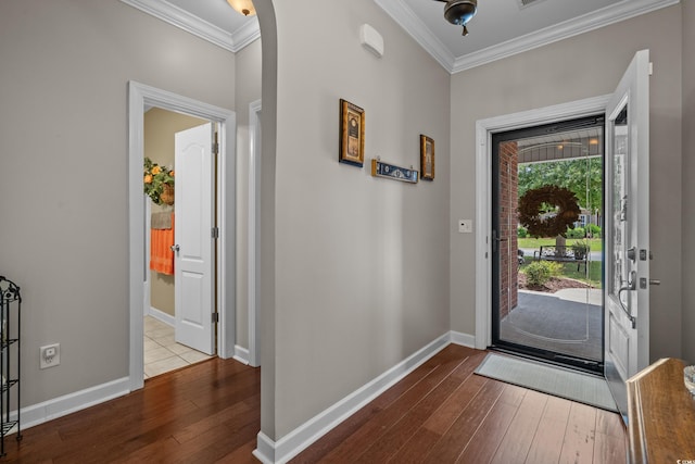 entrance foyer featuring hardwood / wood-style floors, crown molding, and baseboards