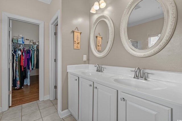 full bathroom featuring tile patterned flooring, ornamental molding, and double vanity