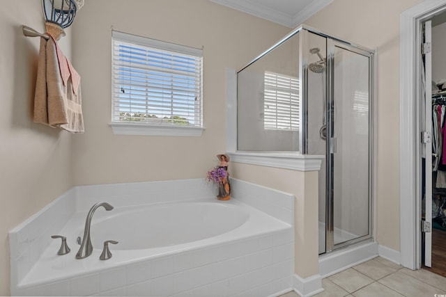 full bathroom featuring a shower stall, a garden tub, ornamental molding, and tile patterned flooring