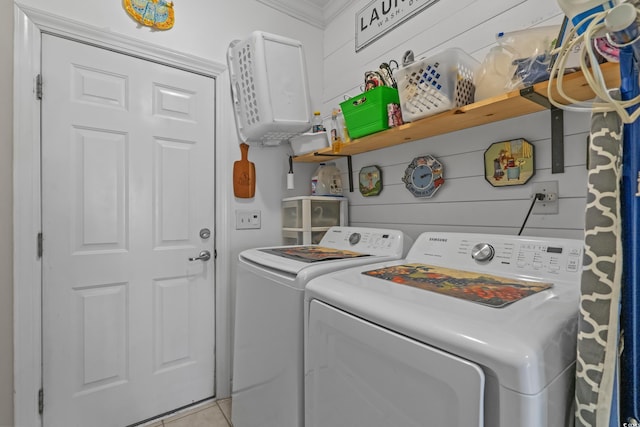 laundry room featuring washer and clothes dryer, light tile patterned floors, and ornamental molding