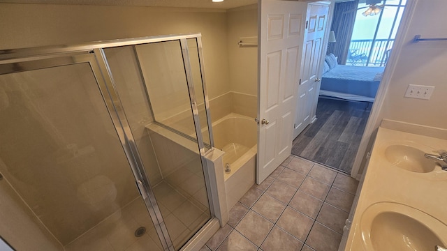 102 N Ocean Blvd Unit 405, North Myrtle Beach, SC 29582 - ensuite bathroom featuring a bath, tile patterned flooring, a shower stall, and double vanity