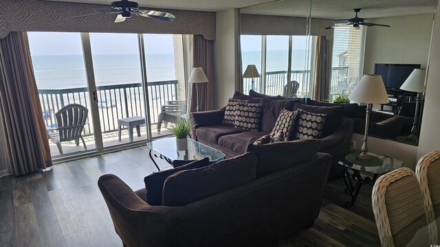 102 N Ocean Blvd Unit 405, North Myrtle Beach, SC 29582 - living area with a ceiling fan, view of water and beach, and wood finished floors