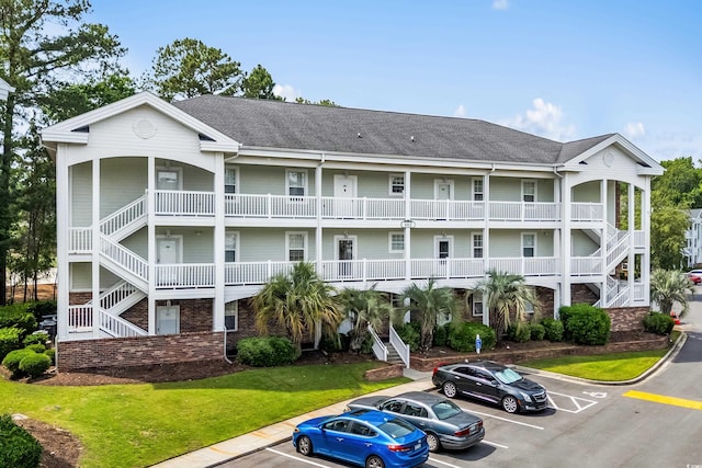 682 Riverwalk Dr Unit 102, Myrtle Beach, SC 29579 - view of property featuring stairway and uncovered parking