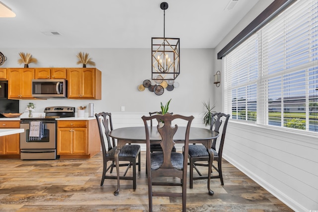 1451 Virginia Pine Dr, Longs, SC 29568 - dining space featuring wood finished floors, wainscoting, and a chandelier