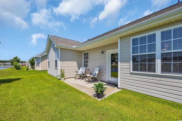 1451 Virginia Pine Dr, Longs, SC 29568 - back of property with a patio, a lawn, and a shingled roof