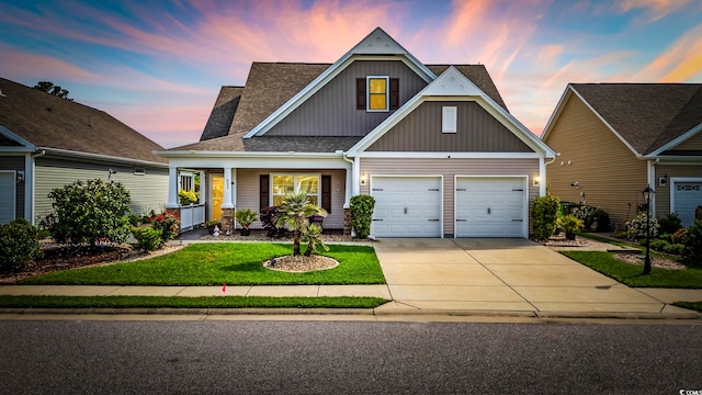 605 Ginger Lily Way, Little River, SC 29566 - craftsman-style home with driveway, board and batten siding, a lawn, a garage, and a shingled roof