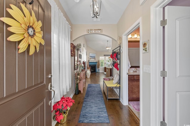 605 Ginger Lily Way, Little River, SC 29566 - foyer entrance featuring arched walkways, a ceiling fan, dark wood-style flooring, a fireplace, and vaulted ceiling