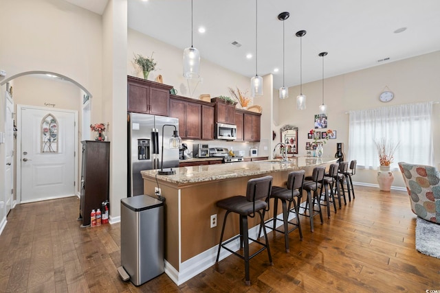 605 Ginger Lily Way, Little River, SC 29566 - kitchen with appliances with stainless steel finishes, a high ceiling, a large island, a kitchen bar, and a sink
