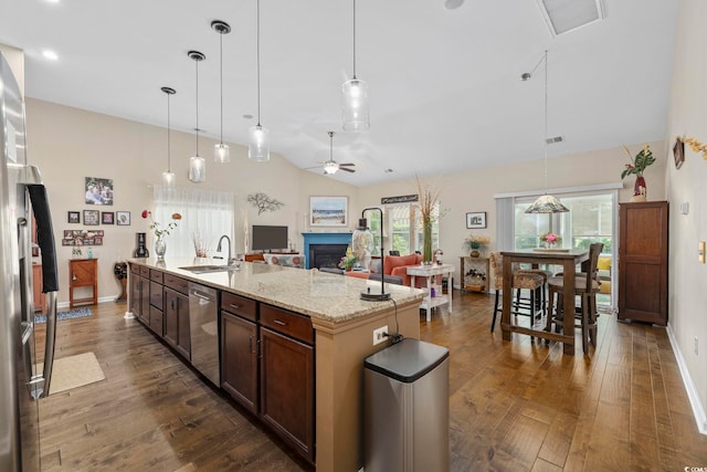 605 Ginger Lily Way, Little River, SC 29566 - kitchen with appliances with stainless steel finishes, a sink, a fireplace, dark wood finished floors, and vaulted ceiling