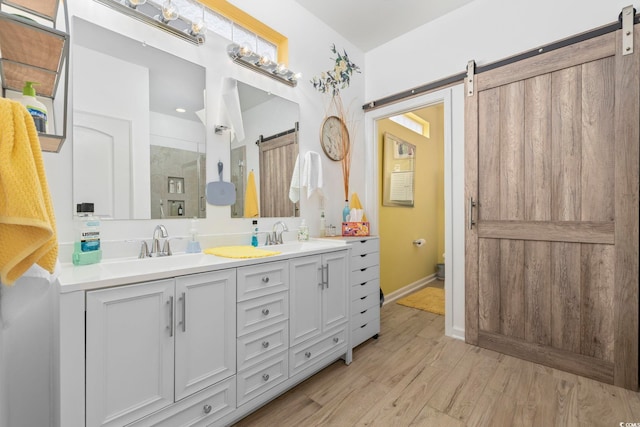 605 Ginger Lily Way, Little River, SC 29566 - bathroom with wood finished floors, double vanity, a shower, and baseboards