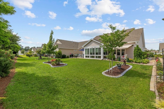 605 Ginger Lily Way, Little River, SC 29566 - back of property with a yard, roof with shingles, and a sunroom